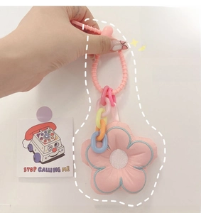 Pink plush flower charm with colorful chain links and spiral cord accessory