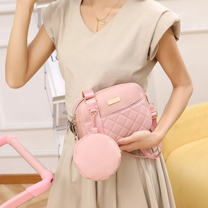 Elegant pink quilted crossbody bag for women featuring a matching round coin purse charm