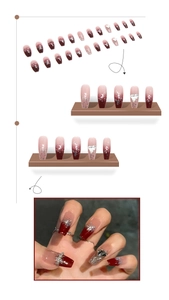 Detail of burgundy gradient press-on nails with silver glitter and heart crystal accents