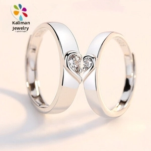 Close-up of S925 silver heart-shaped couple rings with shimmering cubic zirconia