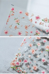 Macro detail of Japanese-style pink cherry blossom nail stickers with 3D embossed texture