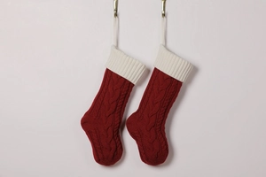 Close-up of red and white cable knit Christmas stockings with hanging loops for holiday decor