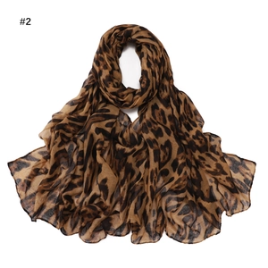 Detail of soft leopard print bali yarn scarf with elegant folds and brown black pattern