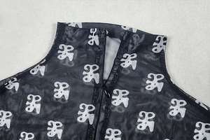 Detail view of the high-neck mesh bodysuit featuring abstract prints and a back zipper closure
