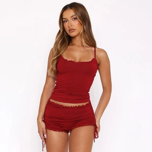 Detail view of red two-piece lounge set featuring camisole top and drawstring shorts
