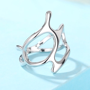 Macro side view of silver liquid-style ring with modern hollow aesthetic and high polish