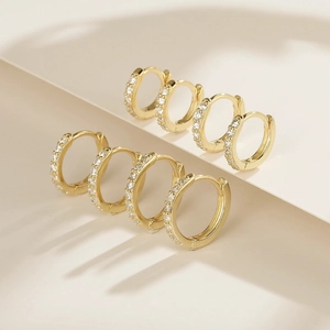 Minimalist gold plated huggie hoop earrings with row of sparkling cubic zirconia