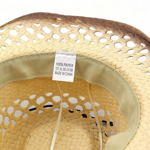 Close-up of hollow straw cowboy hat interior with sweatband and wash label detail