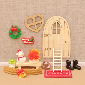 Miniature Christmas dollhouse doorway set with snowman ladder and festive accessories
