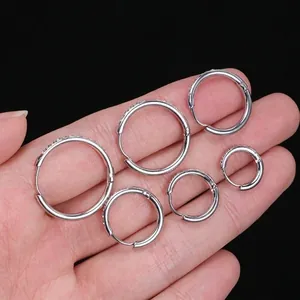 Three pairs of silver stainless steel hoop earrings with crystals in varied sizes