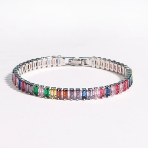 Macro detail of colorful rectangular zircon tennis bracelet with silver prong setting