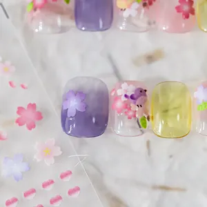 Detail view of Japanese style spring flower nail art stickers and purple gradient press-on nails
