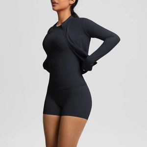 Three-piece black yoga set with zipper jacket and high waist shorts on a model