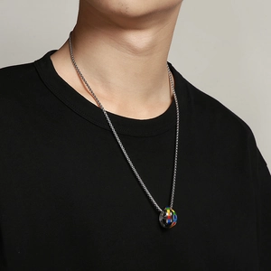 Close-up of interlocking rainbow circles pendant on silver box chain for men