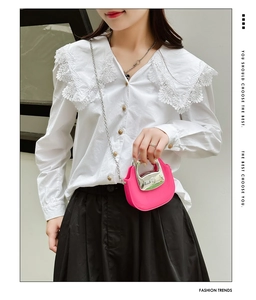 Chic mini pink crossbody bag with silver metal handle on stylish model outfit