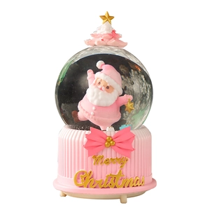 Pink Christmas snow globe with Santa and tree on a gold Merry Christmas base