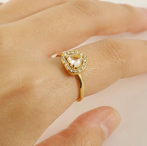 Close-up of double layer heart zircon ring in gold plating on a hand