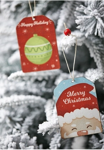 Dettaglio di ornamenti natalizi in legno con Babbo Natale e scritte di Happy Holiday