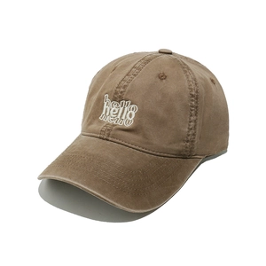 Detail of embroidered hello text on brown washed cotton baseball cap with white background
