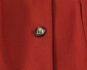 Detailed macro view of high-quality brick red twill fabric with marble texture button