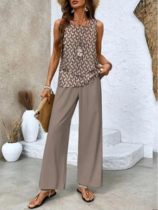 Detail of high-waisted wide-leg trousers paired with a geometric sleeveless crop top