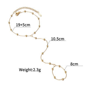 Macro shot of gold layered chain bracelet ring set with bead detail and size markers