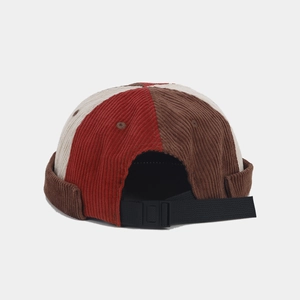 Detail of multi-color corduroy docker cap featuring adjustable buckle and nylon strap