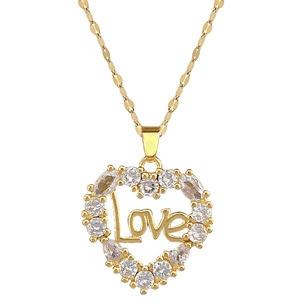 Elegant gold heart love pendant necklace with clear cubic zirconia on a white background