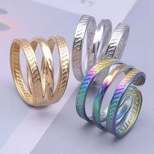 Three-layer geometric rings in gold, silver, and rainbow finishes in a group display