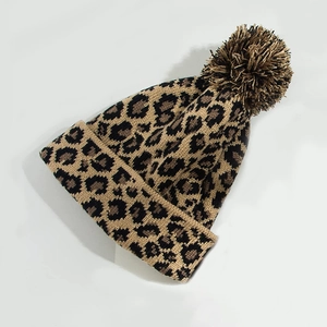 Unisex leopard print knitted beanie hat with fluffy pompom for autumn and winter warmth