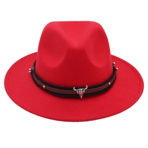 Detail view of red felt fedora with vintage silver bull head and woven band trim