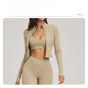Detail of high-waist criss-cross leggings and zippered yoga jacket in beige stretch fabric