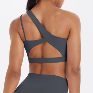 Detail of grey sports bra featuring an asymmetrical open back design with geometric cutouts