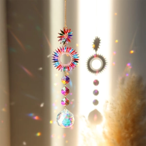 Rainbow crystal suncatcher with golden sun motifs casting light spots on the wall