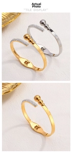 Detailed view of gold and silver steel bangles with side pavé crystals and metal beads