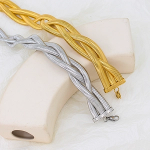 Detailed view of triple-layered woven metal chokers in gold and silver finish
