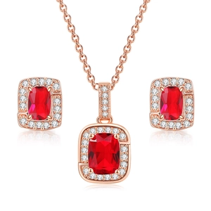 Detail of rose gold jewelry set featuring square red stones and sparkling accents