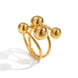 Modern gold plated ring featuring a unique four-sphere geometric design on white background