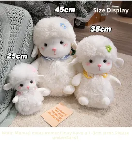Detailed view of three sizes of plush white sheep toys with lace bows and flower embroidery