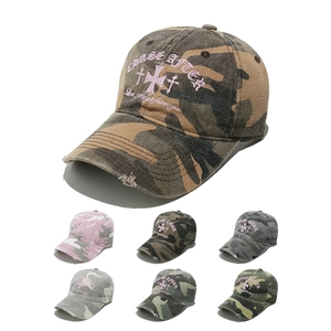 Detail showing multiple camo baseball caps with distressed brims and embroidery