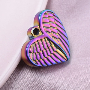 Detailed macro view of an iridescent rainbow heart pendant with wings and top hole
