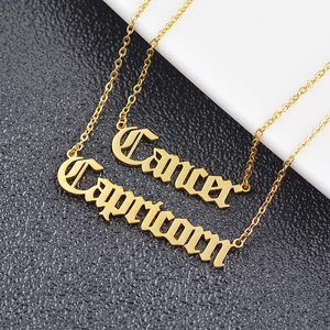 Gold stainless steel zodiac necklace featuring Cancer and Capricorn gothic letter pendants