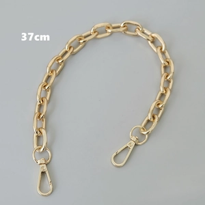 Close-up of 37cm gold metal bag chain with polished surface and lobster clasps