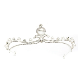 Detailed close-up of a silver baroque crown featuring white pearls and sparkling rhinestones