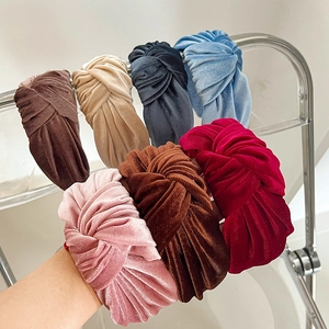 Detail view of colorful velvet knotted headbands in pink brown and blue soft textures
