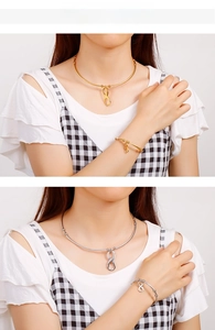 Detailed view of gold and silver infinity symbol necklace and bracelet set on model