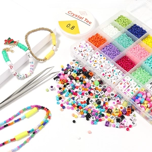 Detail of 24-compartment DIY jewelry kit with colorful beads, elastic cord and tweezers
