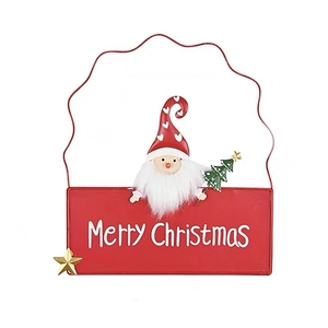 Red metal Merry Christmas sign with a cute gnome and green tree for holiday decor