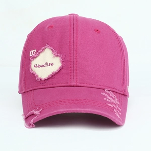 Close-up of distressed cotton baseball cap with vintage embroidery and maple leaf patch