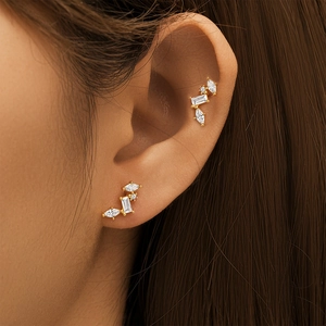 Macro detail of gold-plated S925 silver stud earrings with marquise and drop-shaped cubic zirconia